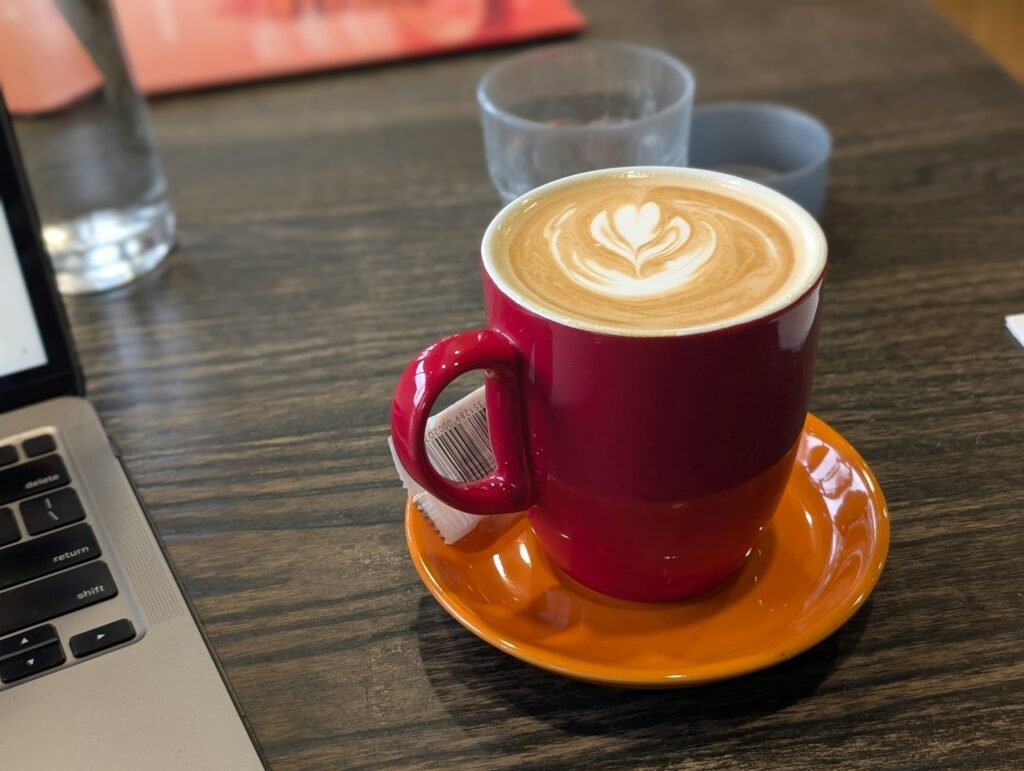 A laptop computer sitting on top of a wooden table